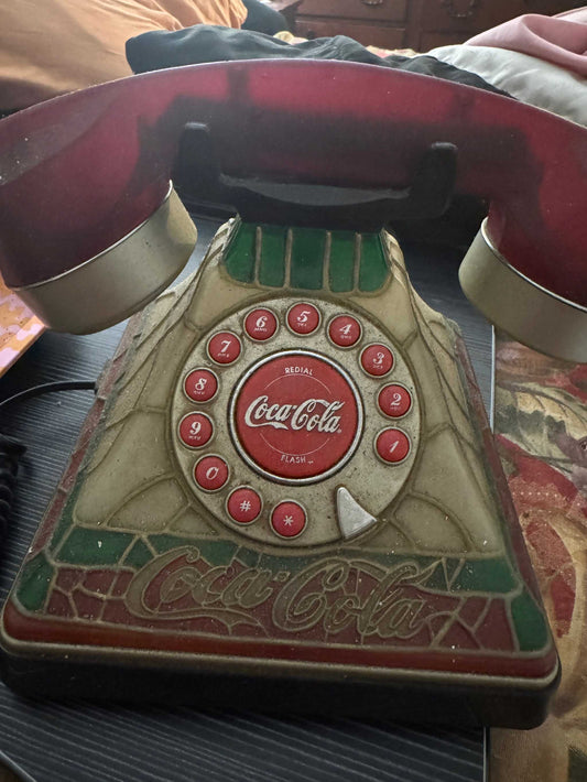 Vintage Coca-Cola stained glass-style rotary push-button telephone with ruby red handset and embossed logo