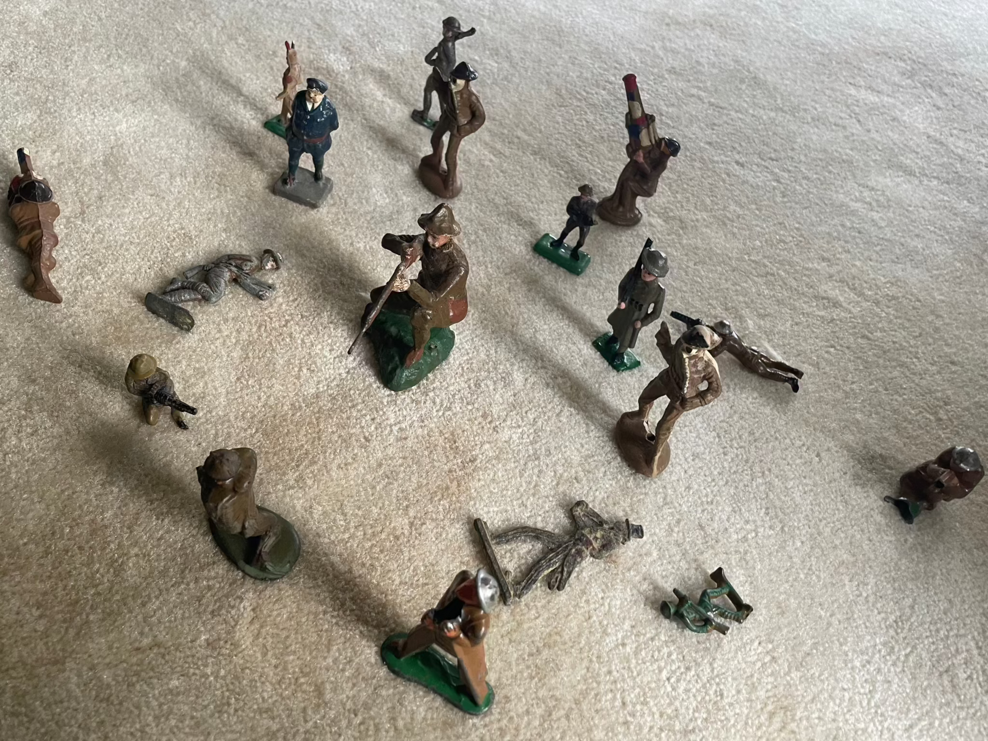 Vintage cast toy combat military soldier figurines arranged on display.