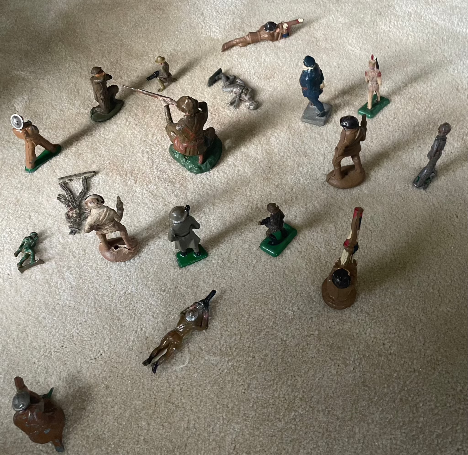 Vintage cast toy combat military soldier figurines on display.