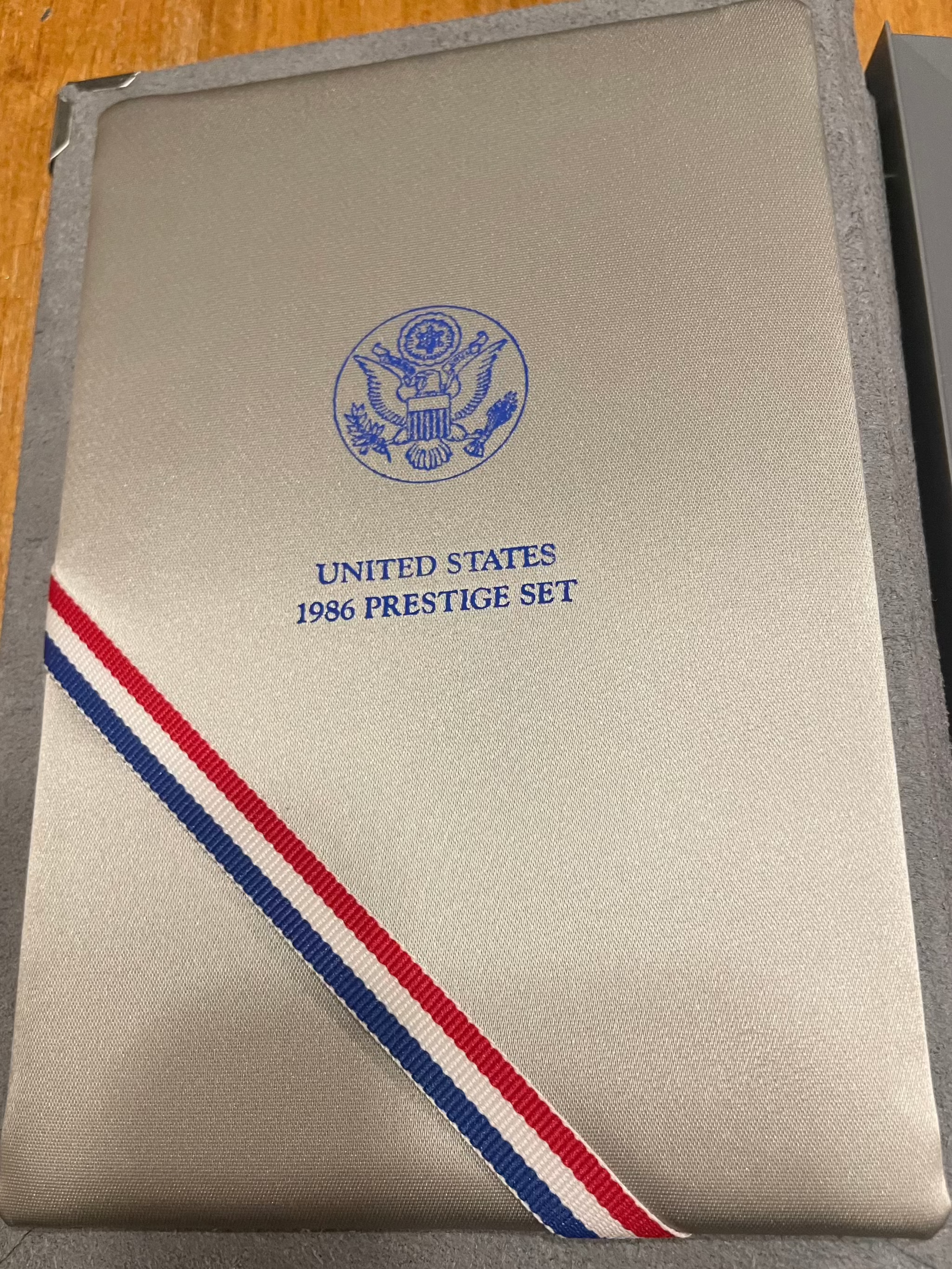 1986 United States Proof Prestige Set packaging with embossed seal and tri-color ribbon.