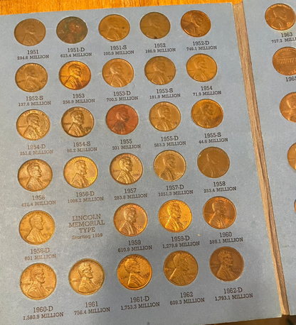 Collector's lot of four penny books including Indian Head pennies and near-mint 1943 steel cents.