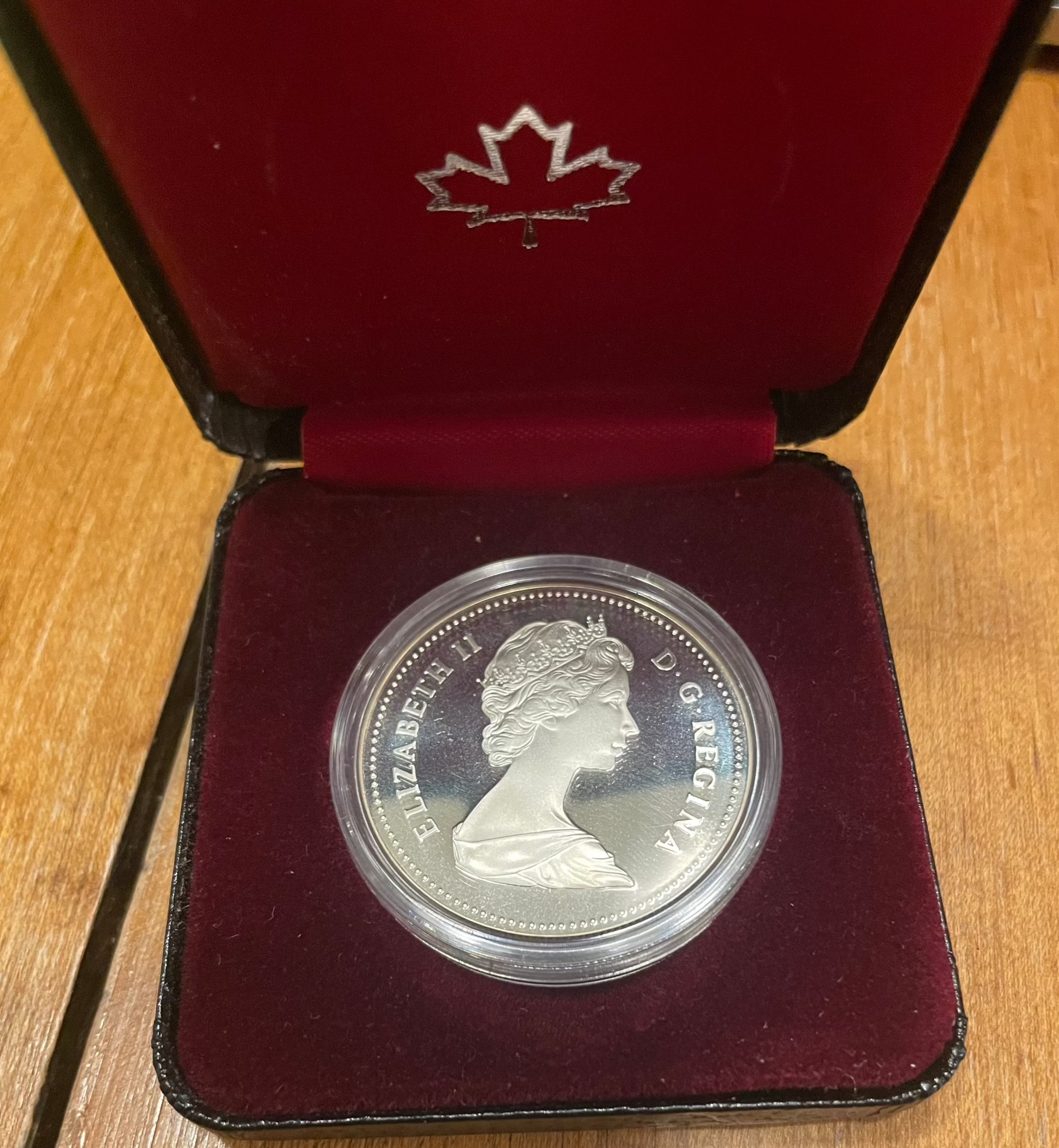 1982 Canada Silver Dollar Regina Centennial coin in display case.
