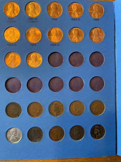 Collector's penny book featuring Lincoln cents, Indian Head pennies, and near-mint 1943 steel cents displayed.
