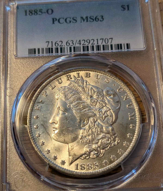 1885 O Morgan Silver Dollar graded MS63 in protective case.