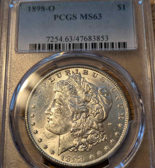 1898 O Morgan Silver Dollar graded MS63 encased for collectors.