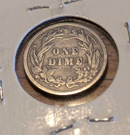 1900 Barber Dime with visible wear, showcasing historical craftsmanship.