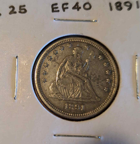 1891 Liberty Seated Quarter with "In God We Trust" motto, featuring Lady Liberty design in fine condition.