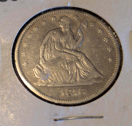 1876 Liberty Seated Half coin with motto, premium F12 quality.