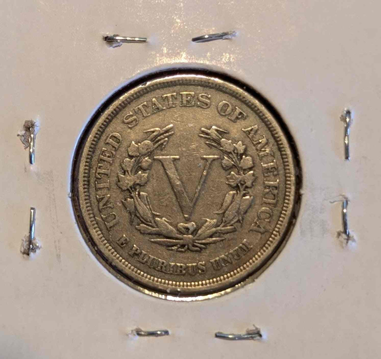 1883 Liberty Head Nickel coin in protective holder, historical collectible.