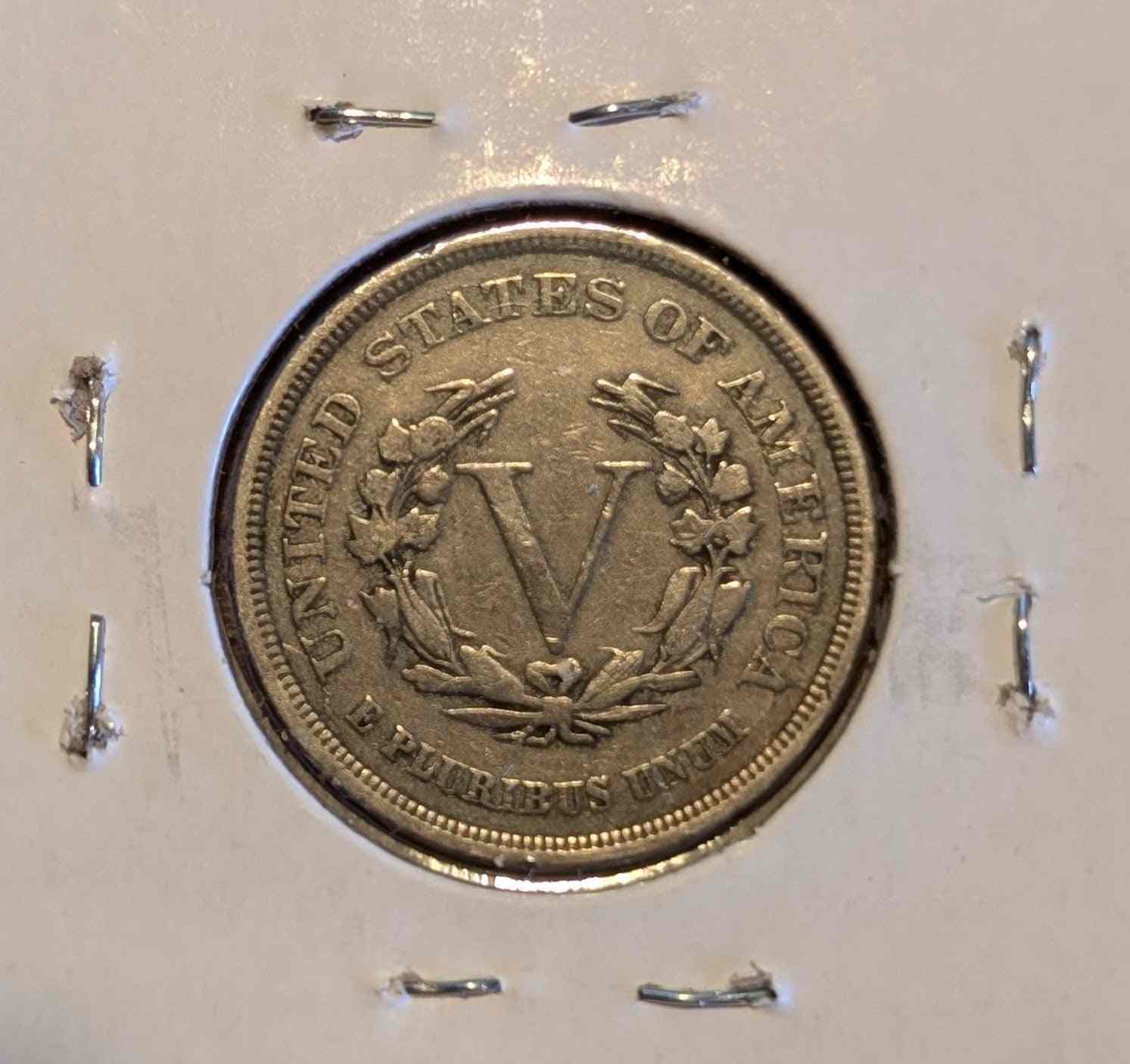 1883 Liberty Head Nickel coin in protective holder, historical collectible.
