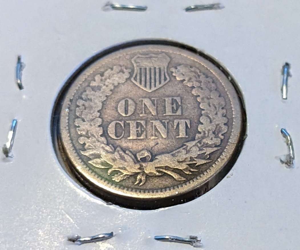 1860 Indian Head Cent coin with "One Cent" inscription and wreath design.