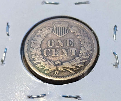 1860 Indian Head Cent coin with "One Cent" inscription and wreath design.