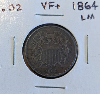 1864 Two-Cent Piece coin with large motto displayed in a collector's holder.