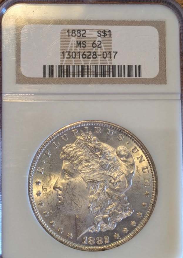 1882 Morgan Silver Dollar in MS62 condition with professional grading display.