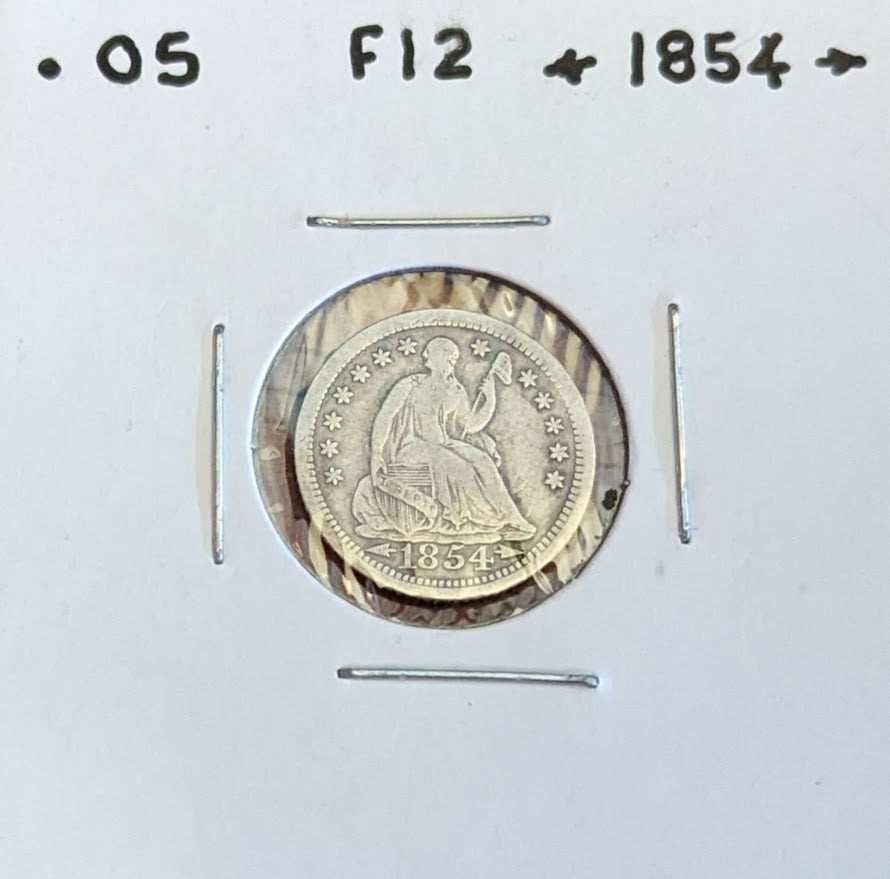 1854 Seated Liberty Half Dime with Arrows, rare collectible coin.