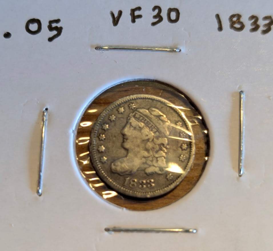 1833 capped bust half dime in very fine condition, collectible historical coin.