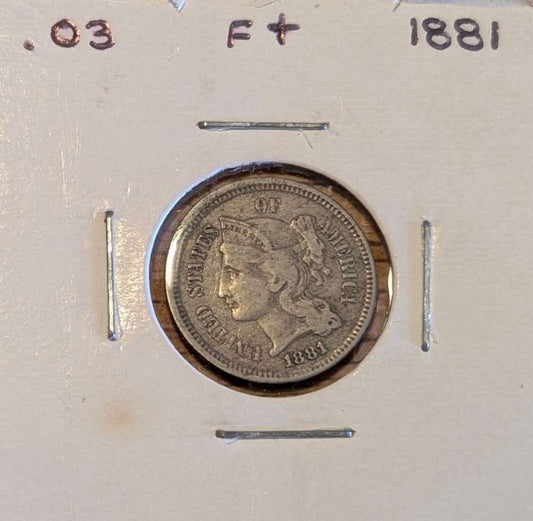 1881 Three-Cent Nickel coin in fine condition showing worn but clear details of the 19th-century US currency piece