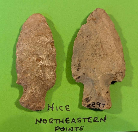 Pair of ancient Northeastern Native American stemmed stone projectile points with patina and old catalog number on display