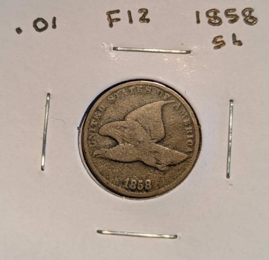 1858 Flying Eagle Cent in worn brown copper-nickel, showing a flying eagle, visible date, and handwritten F12 holder marking.