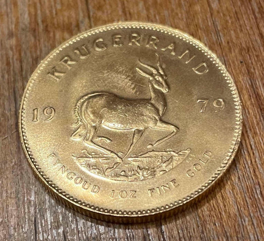 1979 Vintage South African 1 Oz Gold Krugerrand Collectible Bullion Coin on wooden surface.